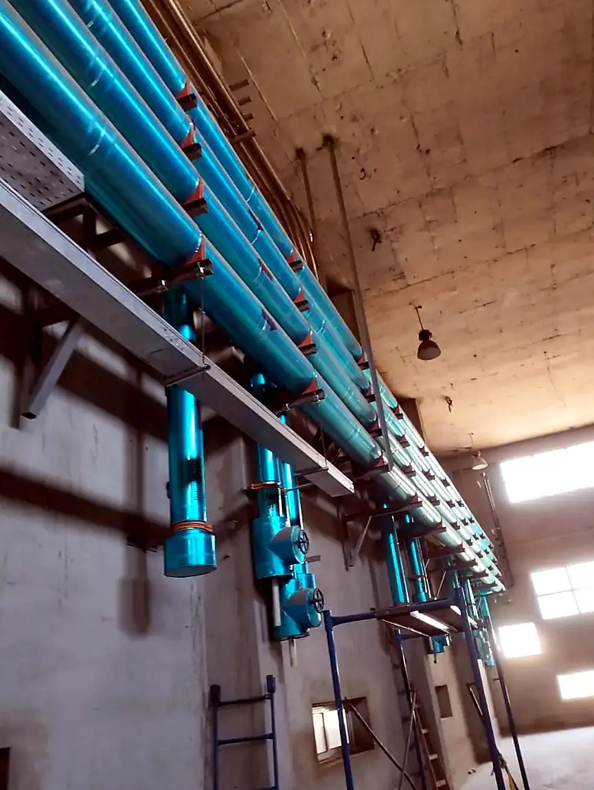 Insulated pipework along a plant room wall