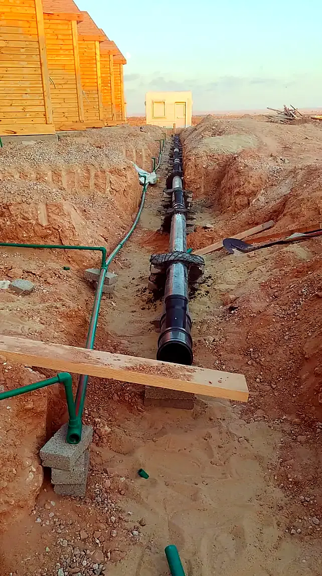 Drainage and water lines in an open trench